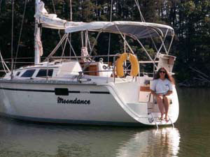 Moondance at anchor with Gail on the stern, June 1999